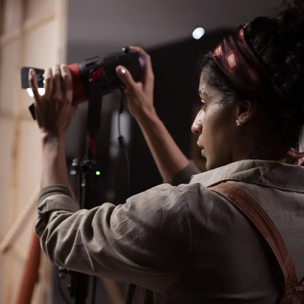 A woman filming with a professional camera.