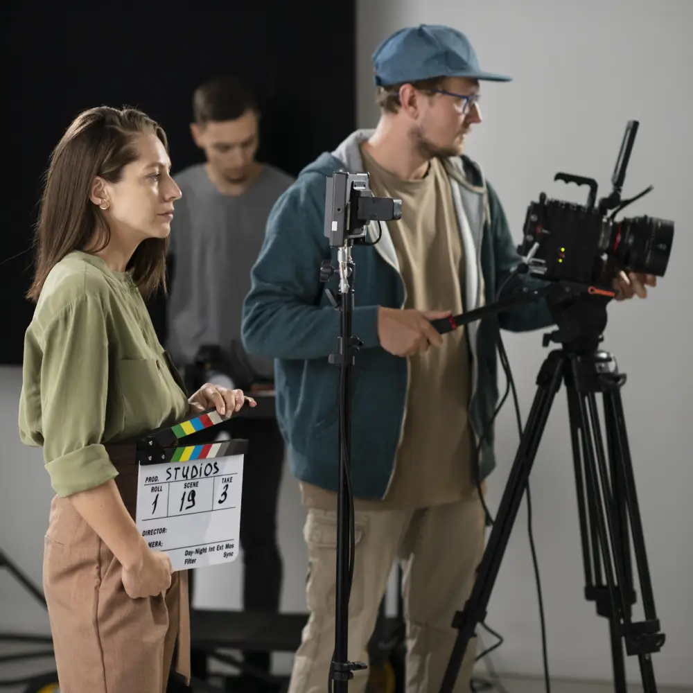Film crew filming a scene in a studio.